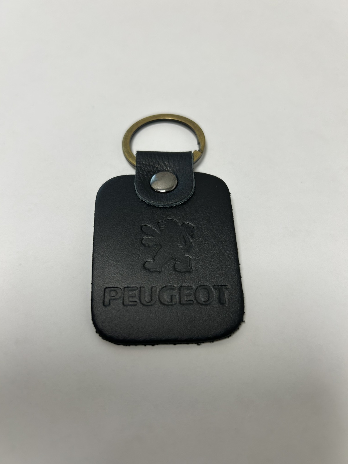 Брелок шкіряний з тисненим логотипом Peugeot, чорний (42595)